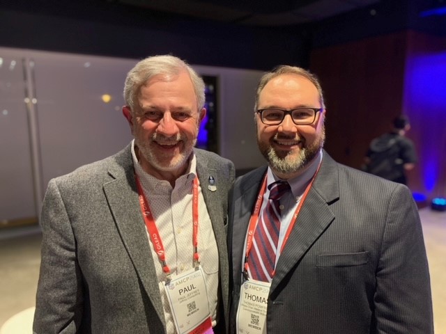 Paul L. Jeffrey, PharmD, consultant, retired Commonwealth Medicine employee, and AMCP Presidency (2021-2022) with pharmacy residency program director and clinical consultant pharmacist team lead Thomas C. Pomfret, PharmD, MPH, BCPS.