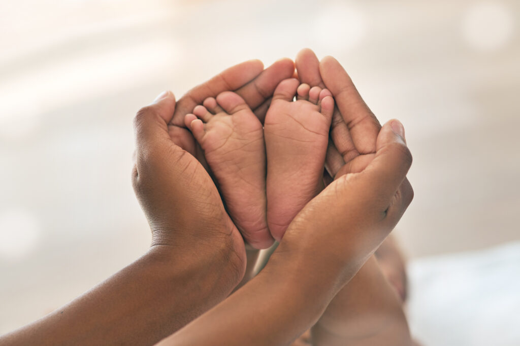 Baby's feet being held by a parent